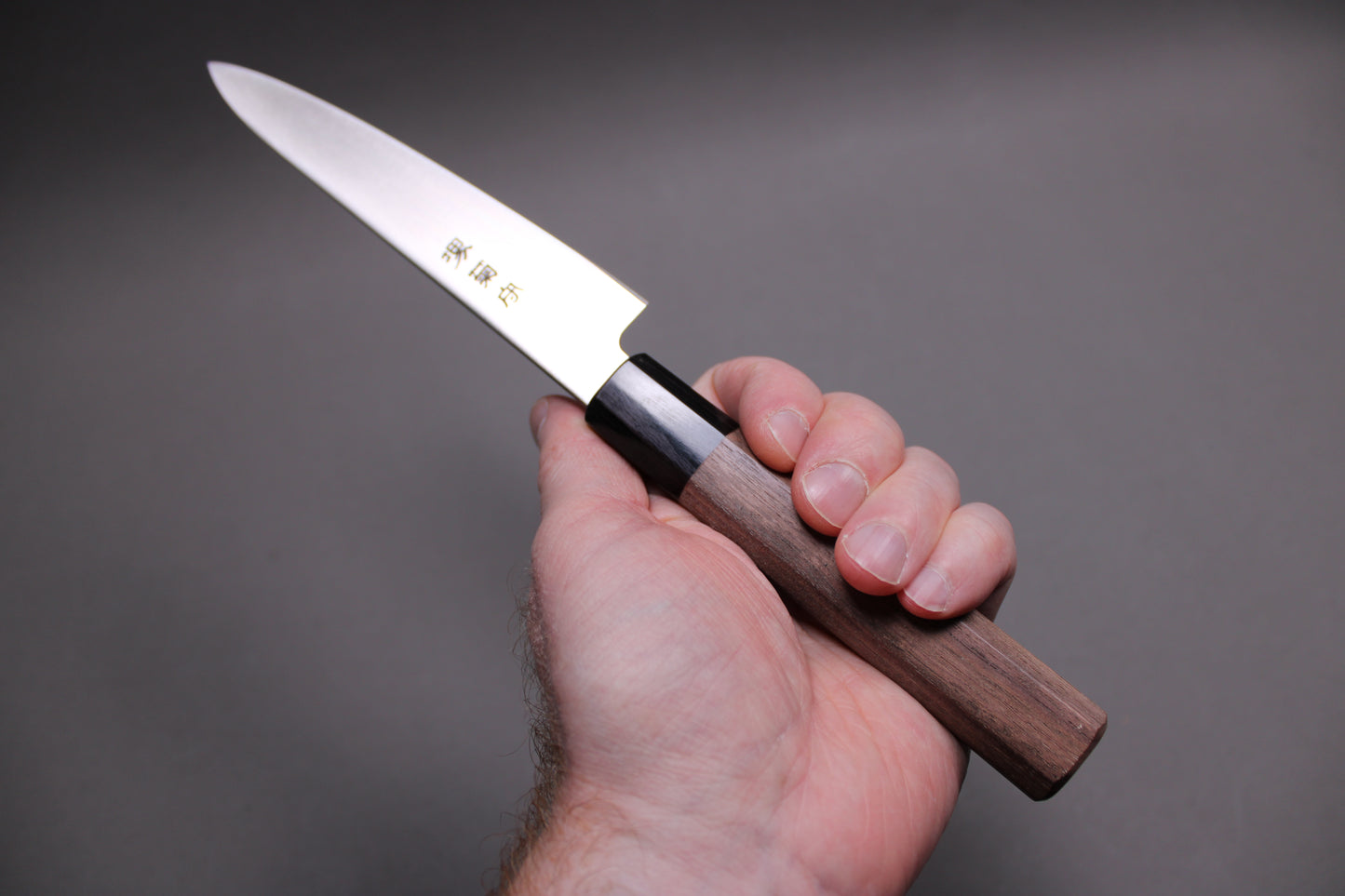 hand holding aus8 vanadium stainless steel petty knife