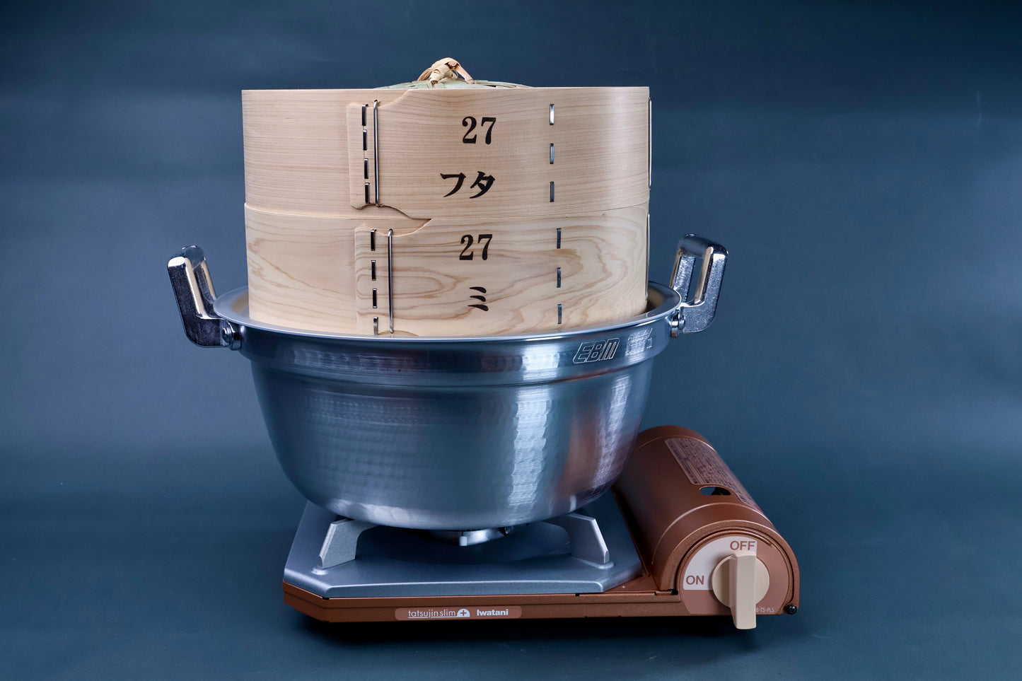 Bamboo steamer kit 27cm assembled on Iwatani portable gas burner showing in-use setup on grey background