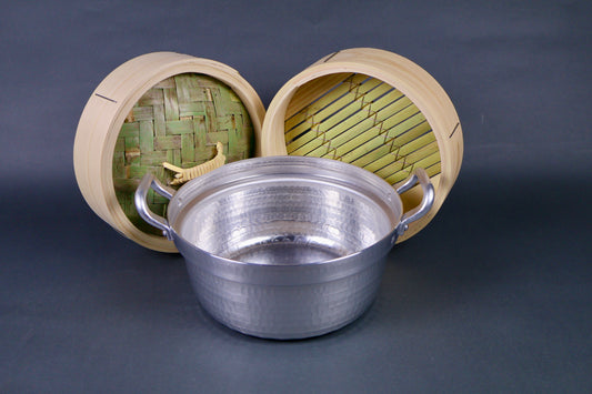 bamboo steamer kit four pieces hammered metallic pot two handles bamboo thick wood steamer lid and base metallic circular steam ring center hole grey background