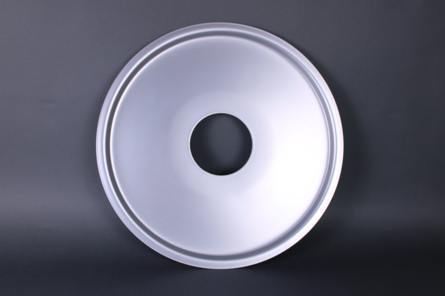 steam ring for cooking japanese kitchenware durable hole in the center to allow steam to pass through frontal shot of ring with grey background