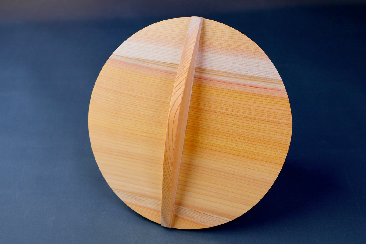 circular wooden drop lid for braising in grey background