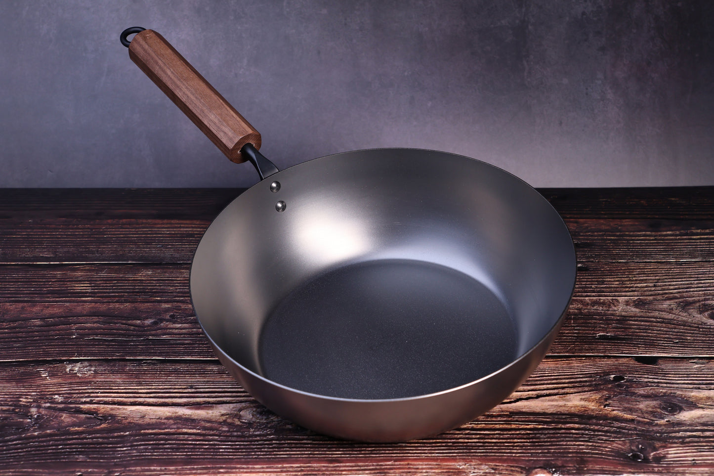 Carbon Steel Nitride deep fry pan 26cm showing dark nitride interior and walnut handle on wood surface