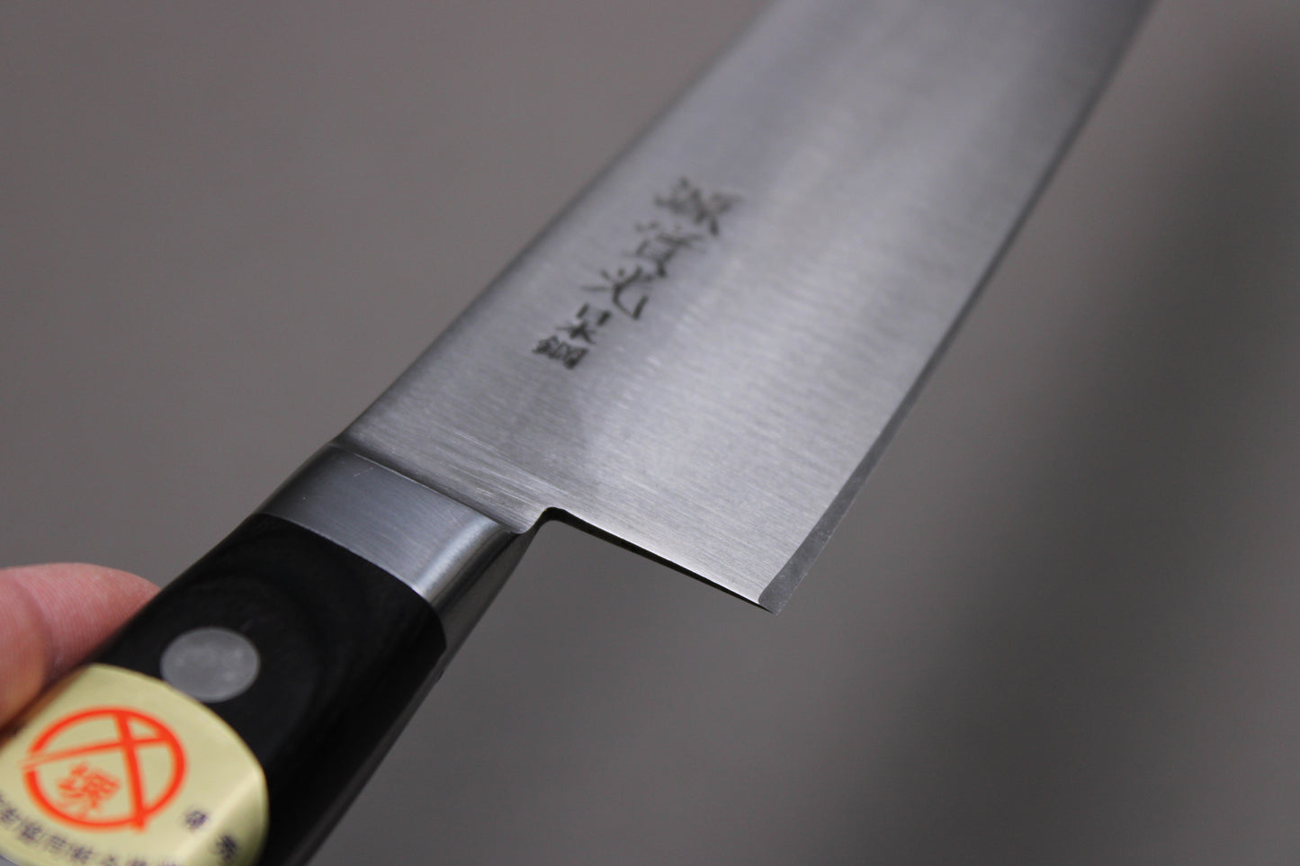 closeup of knife handle and kanji of sakai jikko