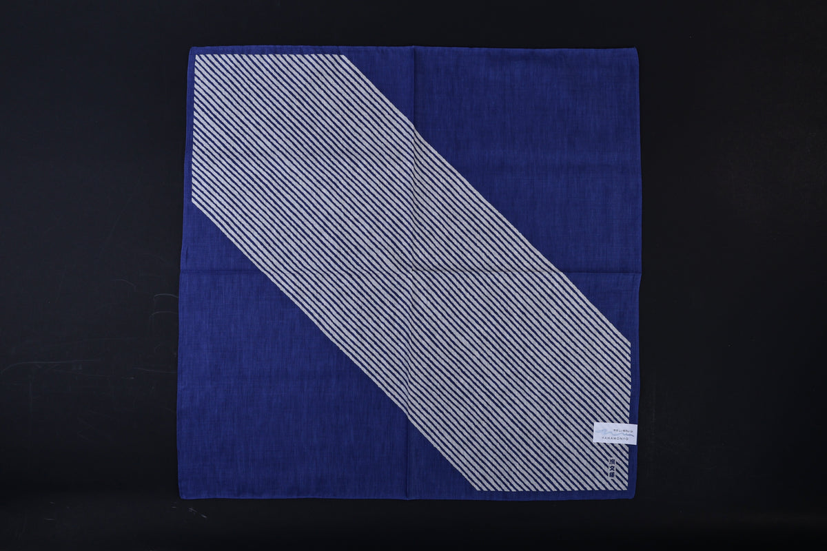 Hamamonyo classified stripes blue tenugui fully unfolded on black background, showing diagonal stripe design against solid blue