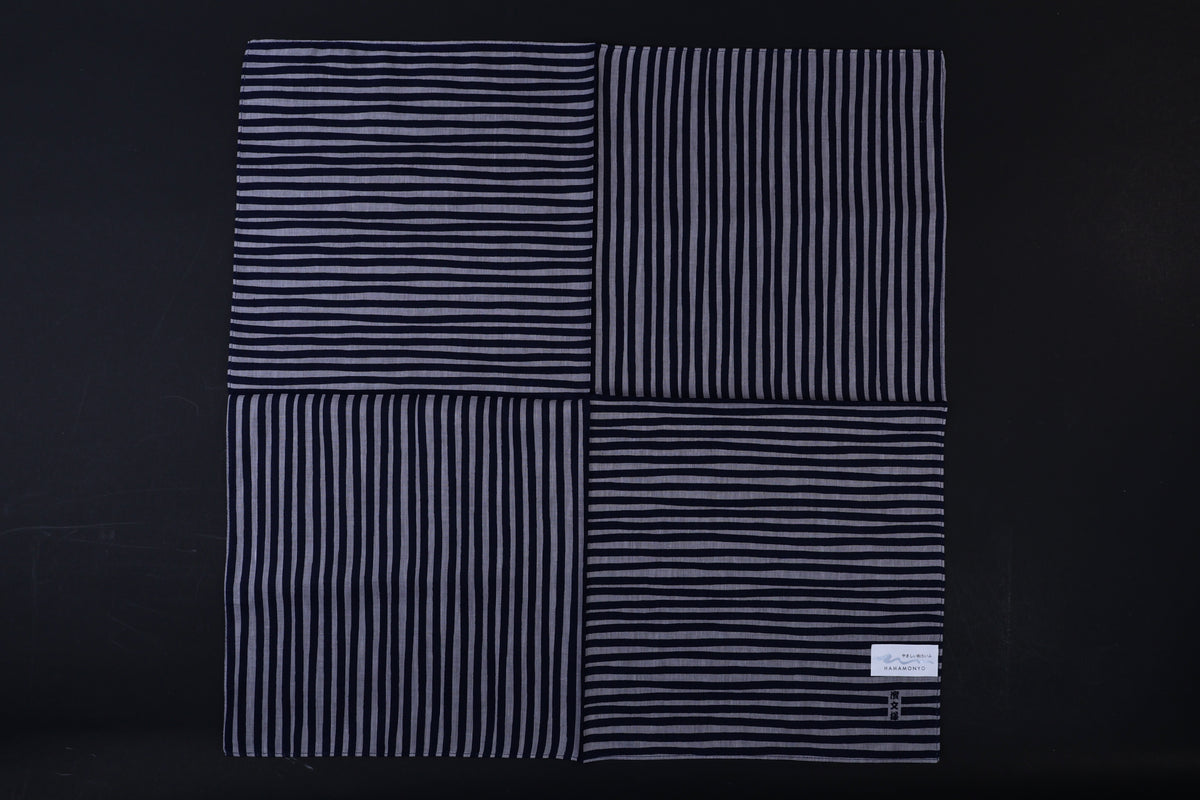 Hamamonyo tateyoko striped tenugui fully unfolded on black background, showing four-panel stripe pattern variation