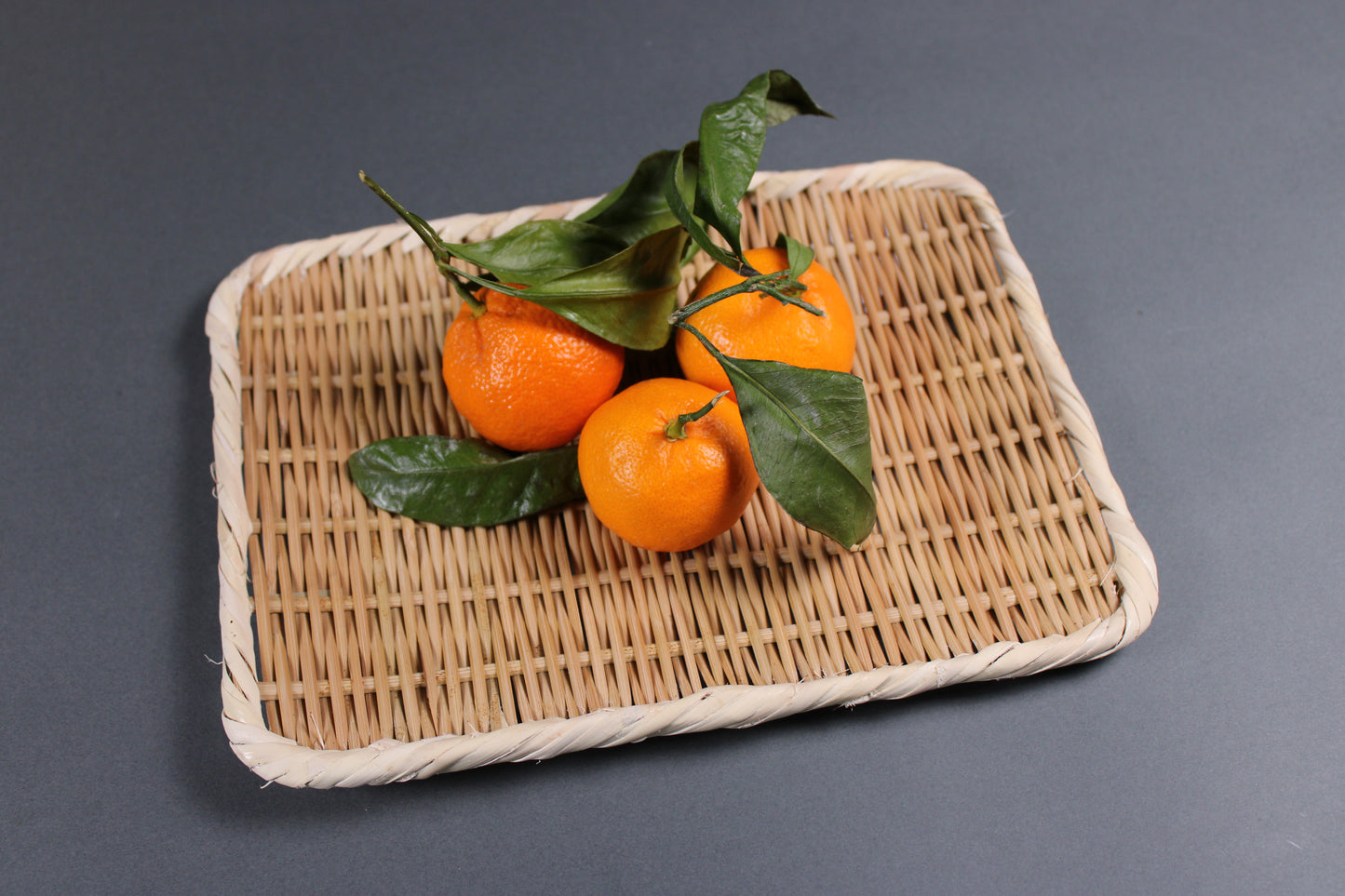 rectangle shaped handmade bamboo plate 21cm from Sado Japan with grey background