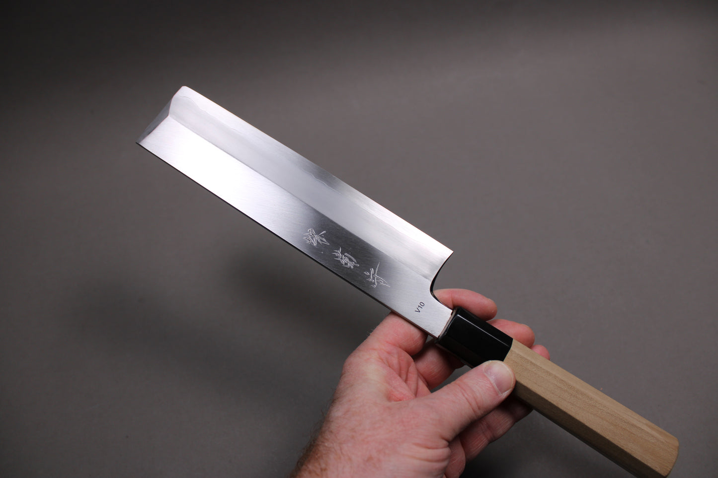hand holding handmade japanese vegetable knife