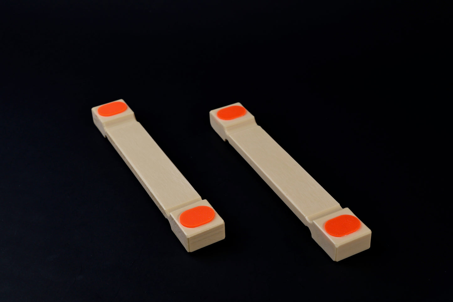 Hasegawa cutting board lifter small — pair side view showing low-profile body and recessed grip pad ends