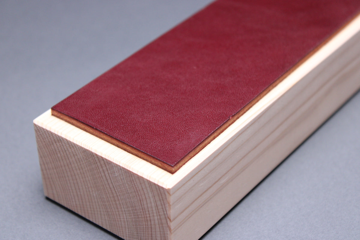 Hinoki espresso leather knife strop — close-up of end showing burgundy leather thickness and hinoki wood grain