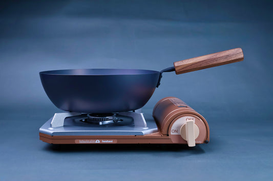Japanese carbon steel nitride deep fry pan 24cm with octagonal hardwood handle on an Iwatani portable gas burner