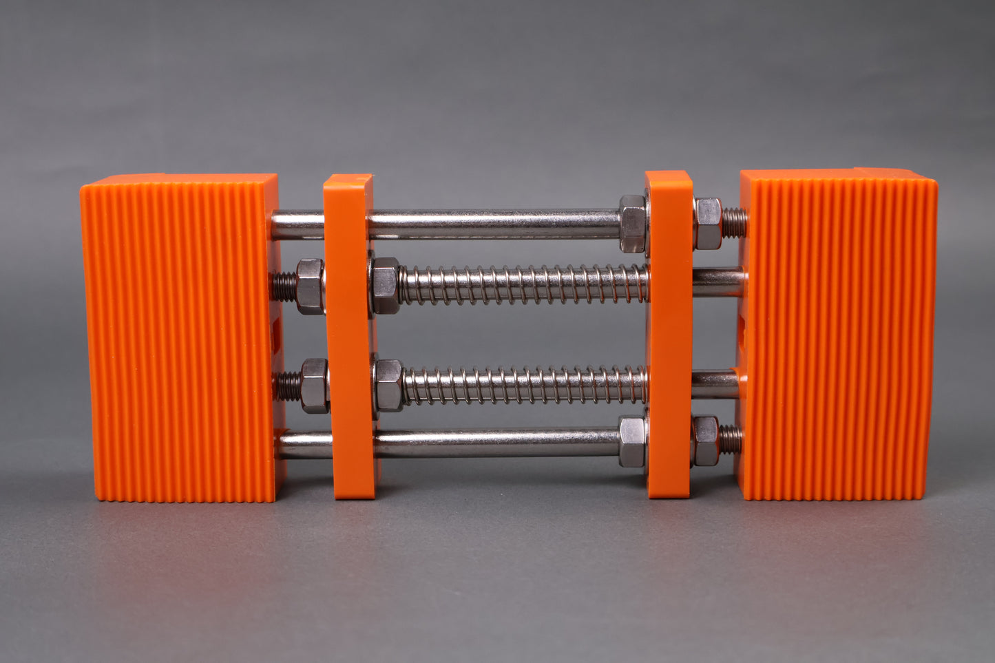 marie whetstone holder rectangular shape orange in color with internal metal springs in grey background