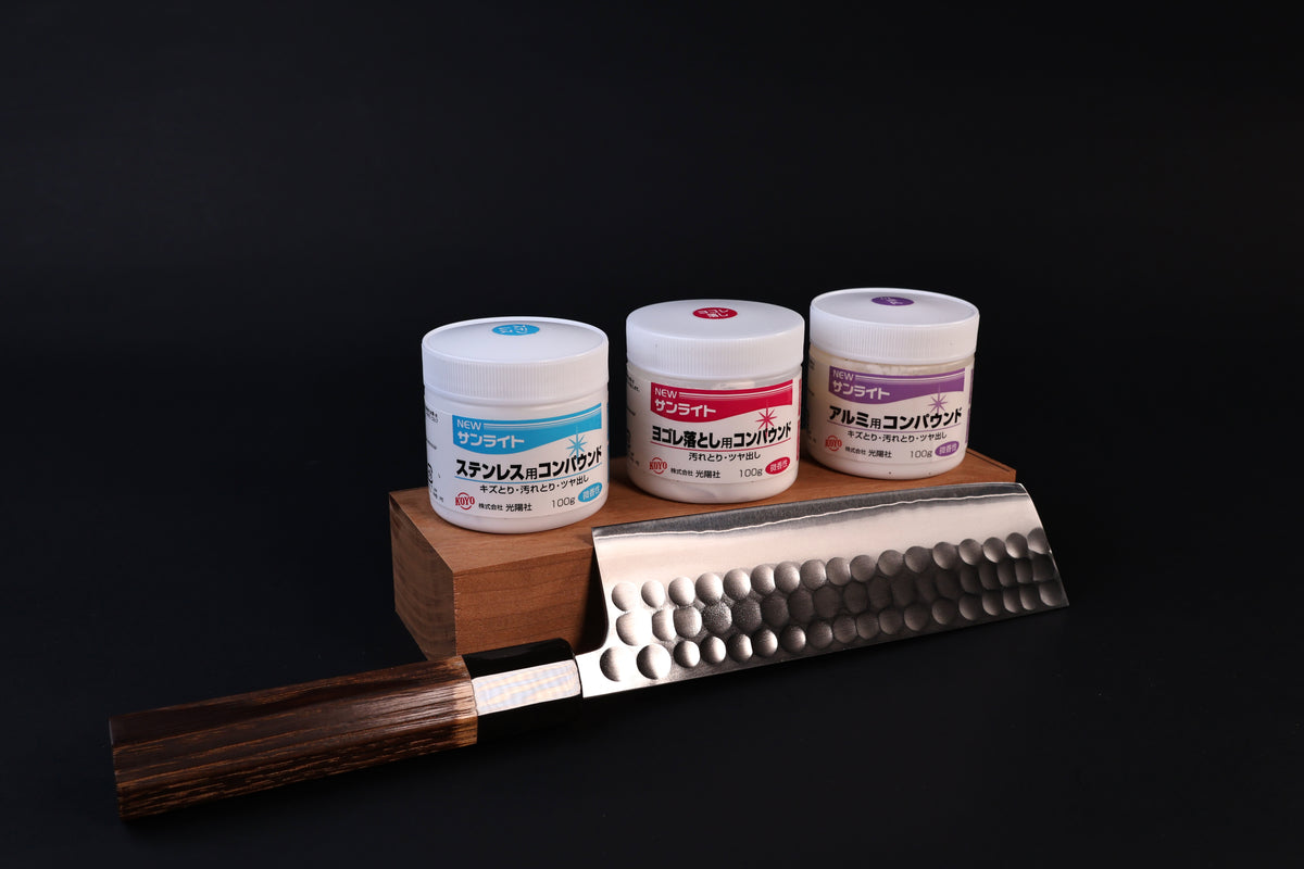 Koyo New Sunlite dirt-remover compound shown with the stainless and aluminum compounds and a hammered Japanese knife