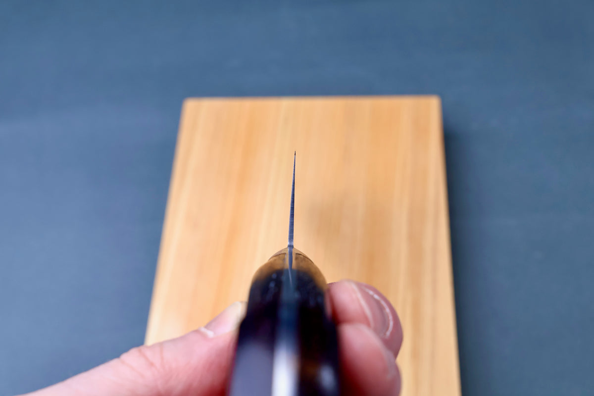Masamoto CT carbon steel gyuto 240mm blade tip viewed straight down the cutting edge