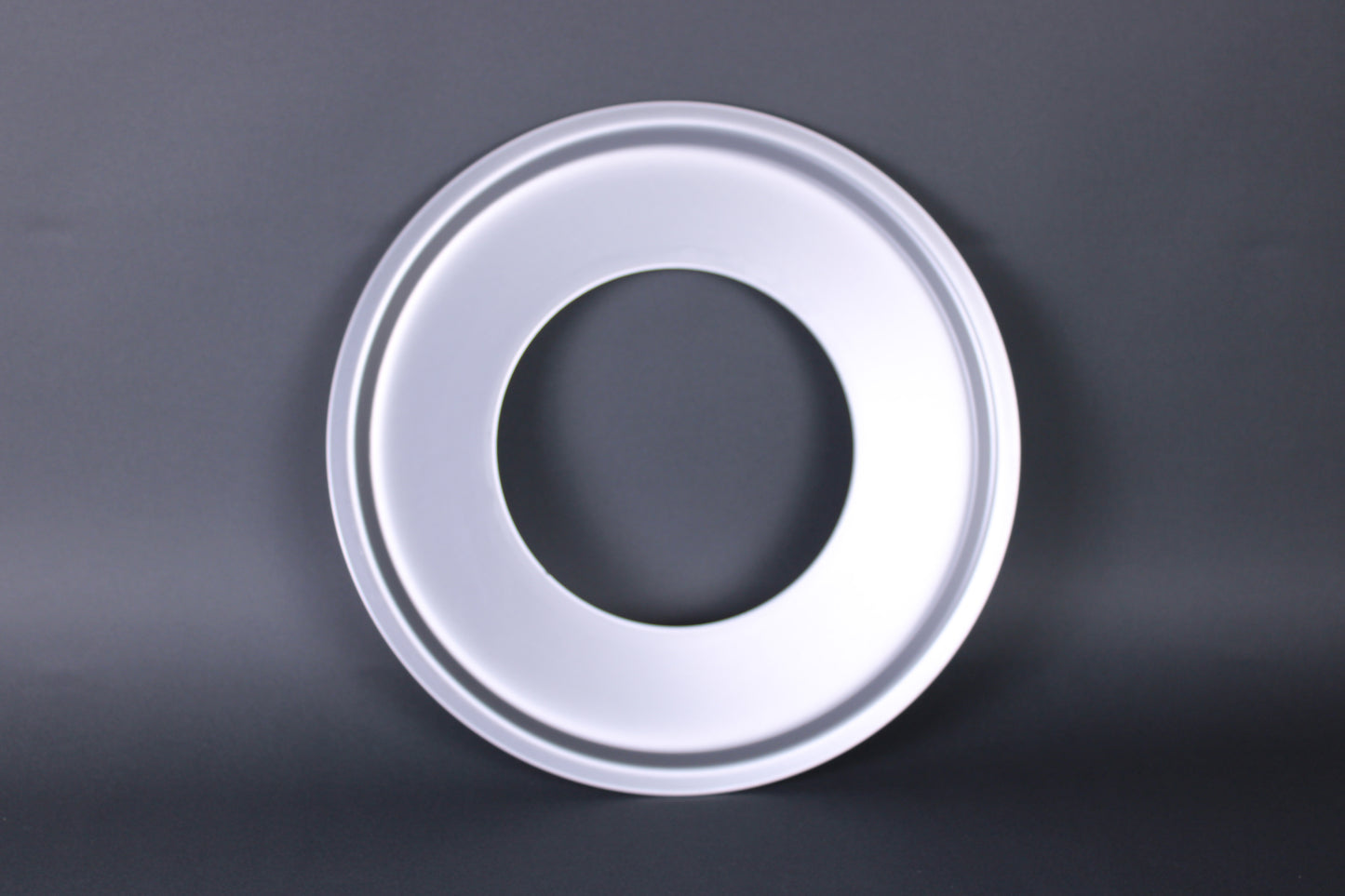 seiro steam ring made in japan aluminum frontal shot with dark grey backdrop showing steeped contours of the ring which is colored silver