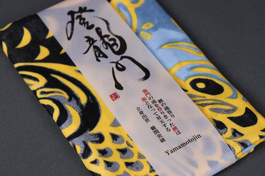 rectangular packaged sarashi towel printed with black blue grey depicting carp fish on dark backdrop