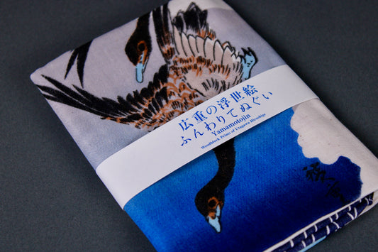 close up of edo geese depicted on fabric with blue and white tones