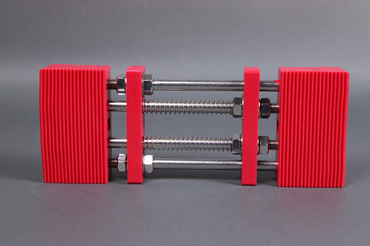 marie whetstone holder rectangular shape red in color with internal metal springs in grey background