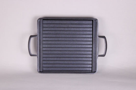 square black grill with 2 handles ridges and removable center plate shown with grey background
