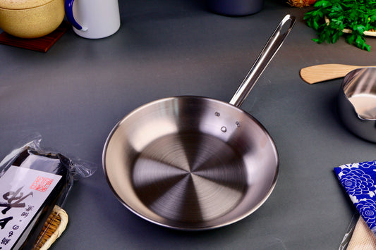 torino saute pan 26cm top down image surrounded by japanese kitchenware grey background