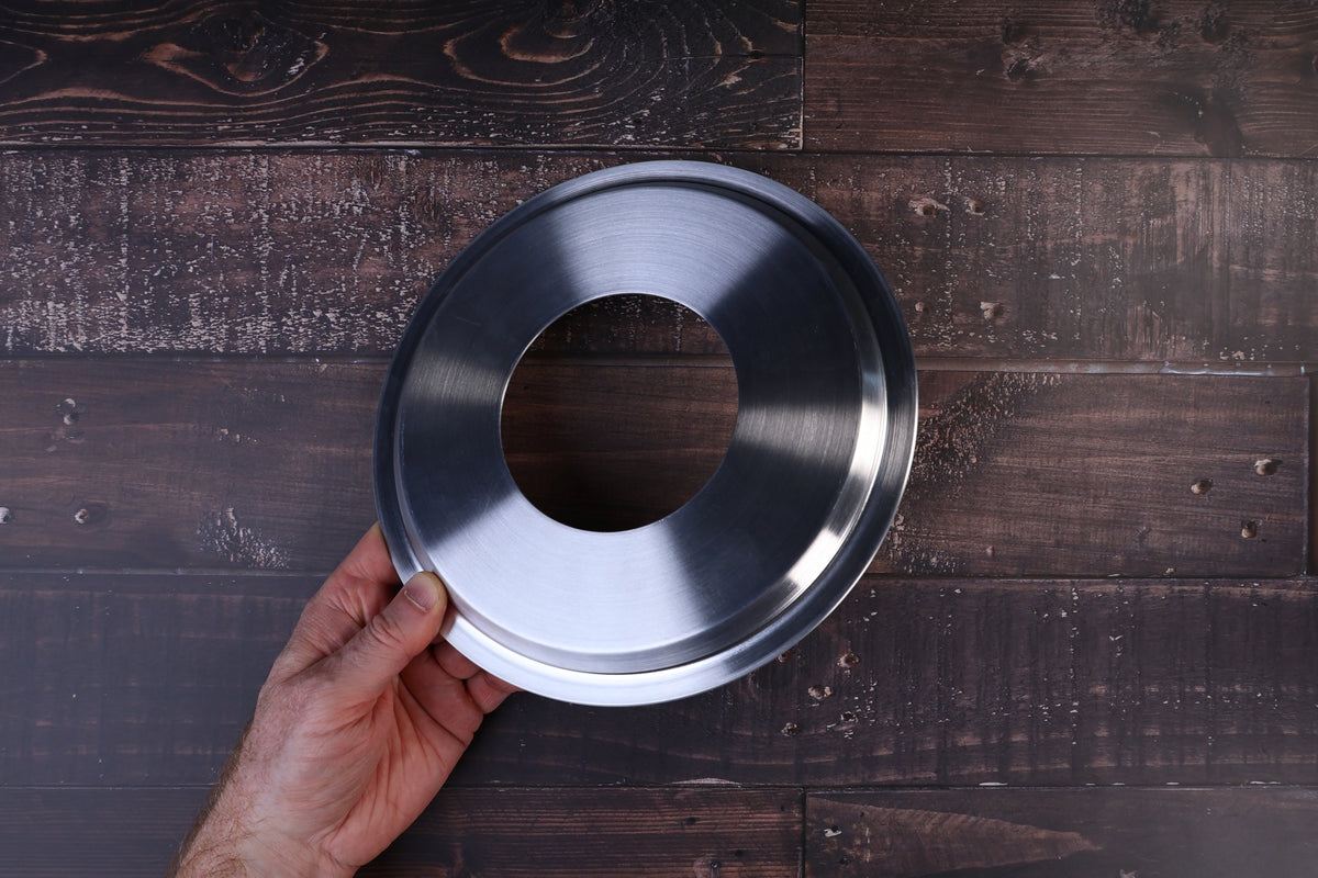 Stainless steel steam ring 21cm held by the rim to show its raised profile and open center