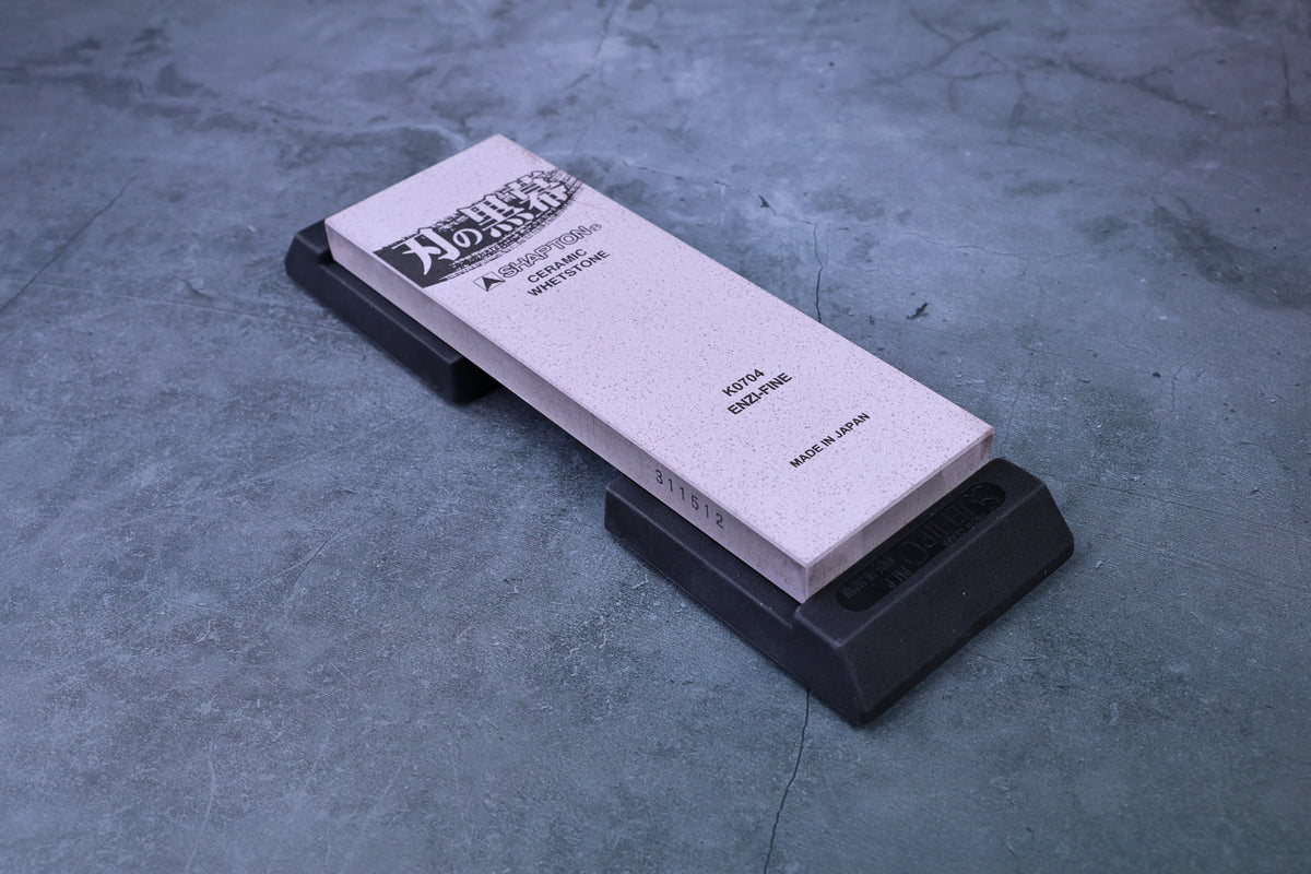Shapton ceramic whetstone seated in Suehiro rubber base, angled view showing stone held securely in holder