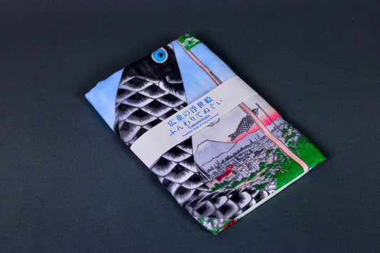 rectangular packaged tenugui towel printed with light blue red  black green classical japanese carp on dark backdrop