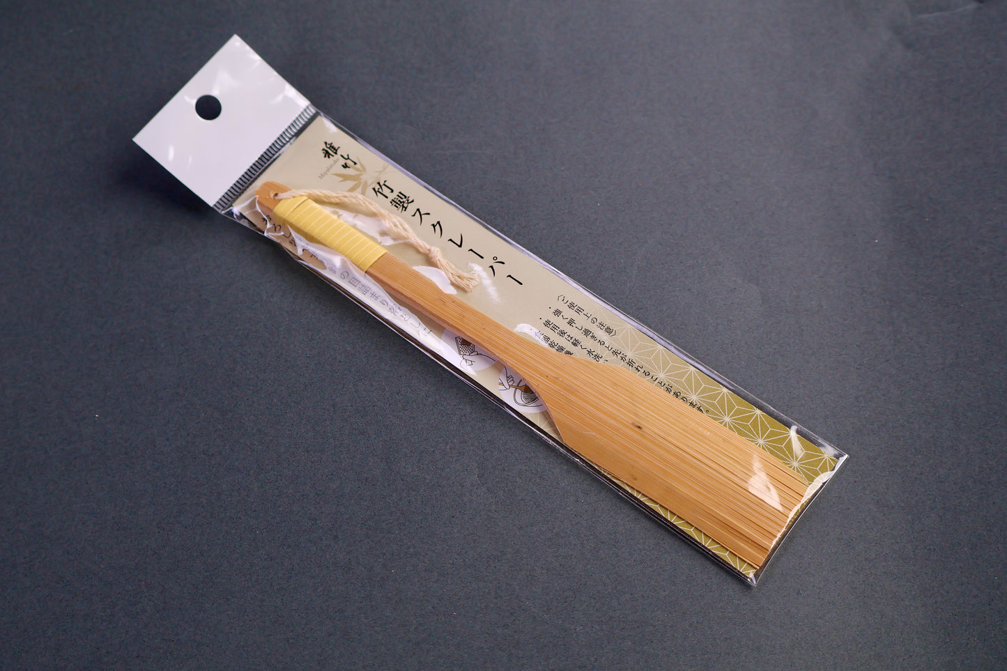 bamboo brush with wrapped handle I plastic packing with hiragana in grey background