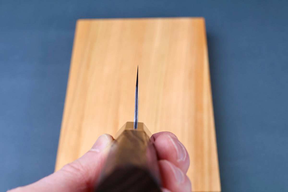 Yoshikane SKD Tsuchime Santoku 165mm blade tip viewed straight down the cutting edge showing thin profile
