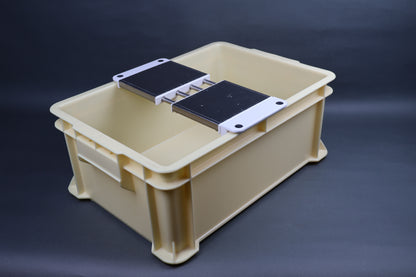 yellowish tan tall narrow sharpening box holding multi sliding rack flat grey backdrop