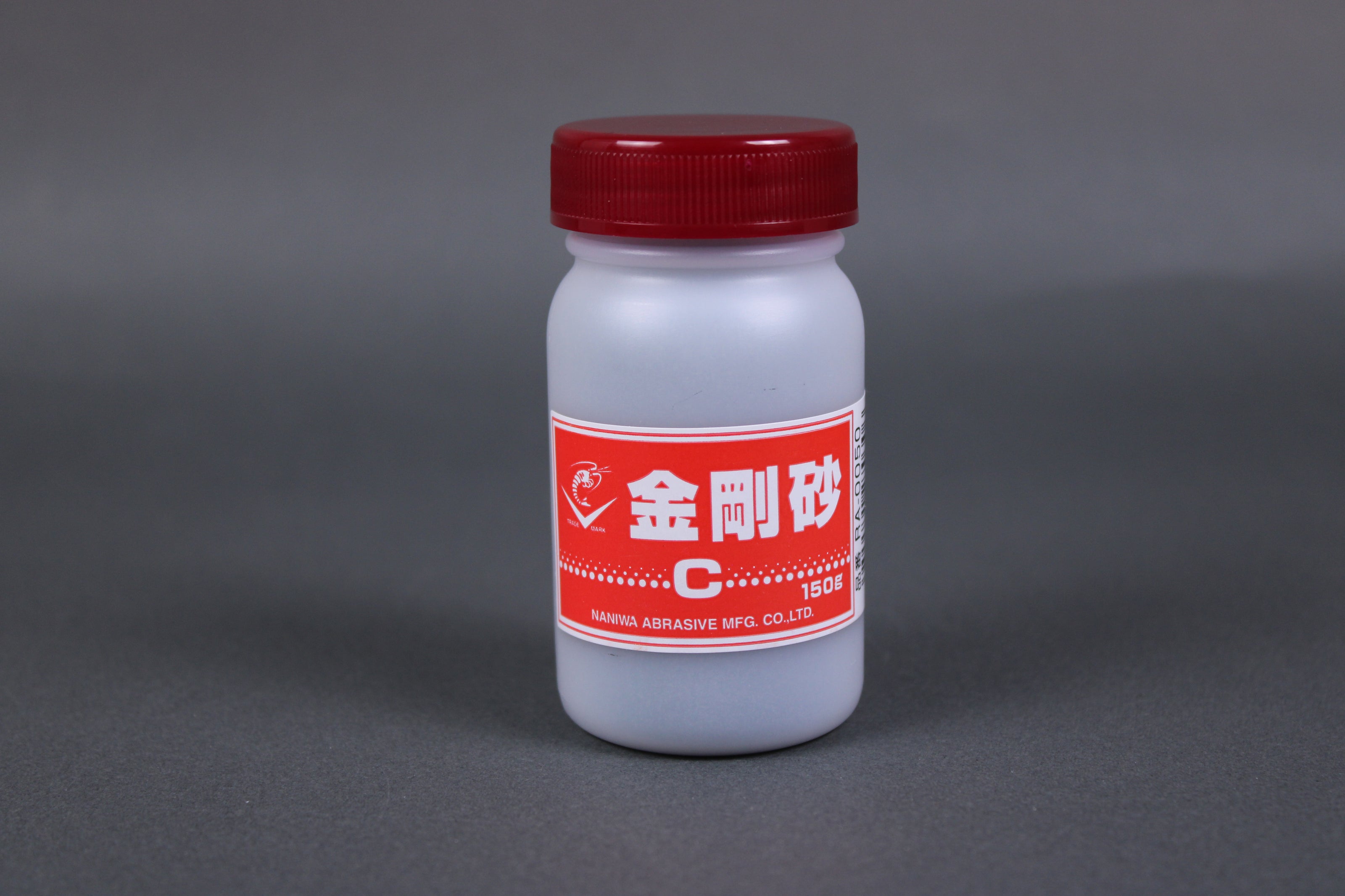 short plastic red capped bottle with Naniwa logo shrimp kanji writing red white label grey background