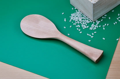 Azmaya handmade rice paddle on green mat with wooden masu box and scattered rice