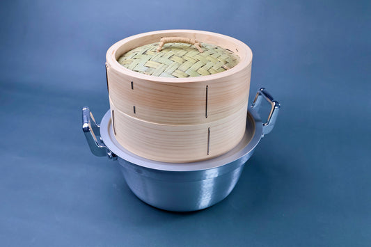 Bamboo steamer kit 21cm close front view showing woven bamboo lid, cedar body with metal staples and aluminum pot on blue background