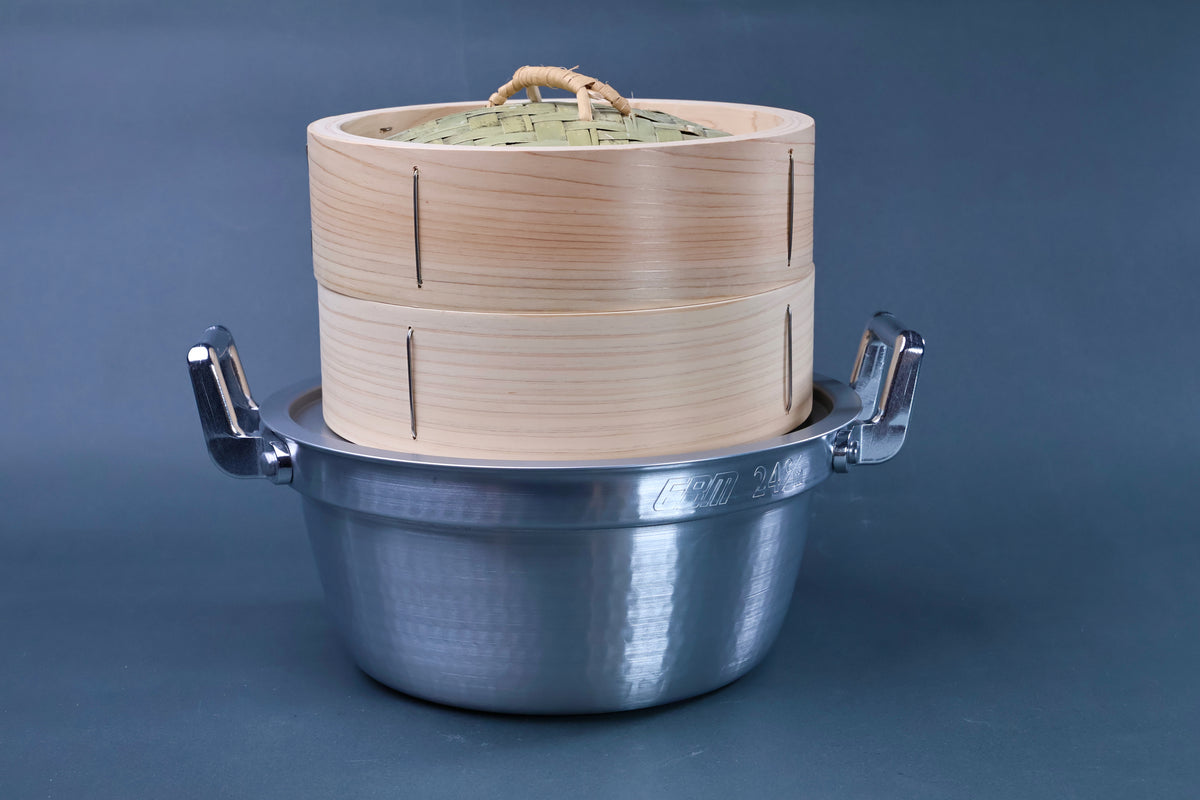 Bamboo steamer kit 21cm assembled front view showing woven bamboo lid, cedar body and chrome-handled aluminum pot on blue-grey background