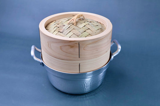 Bamboo steamer kit 21cm with dantsuki pot close three-quarter view showing woven bamboo lid and cedar grain body in hammered aluminum pot
