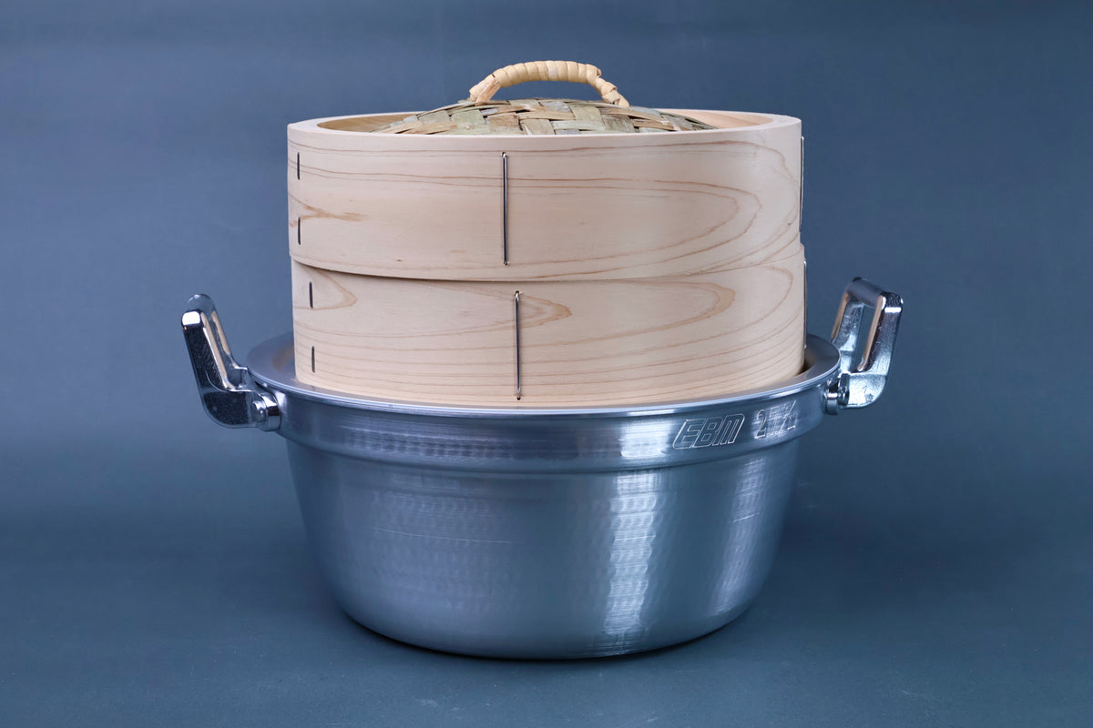 Bamboo steamer kit 24cm assembled showing clean cedar grain steamer body and woven bamboo lid in hammered aluminum pot on blue-grey background