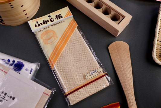 whitish tan cotton steamer cloth for steaming food in partially clear plastic package displaying japanese name 