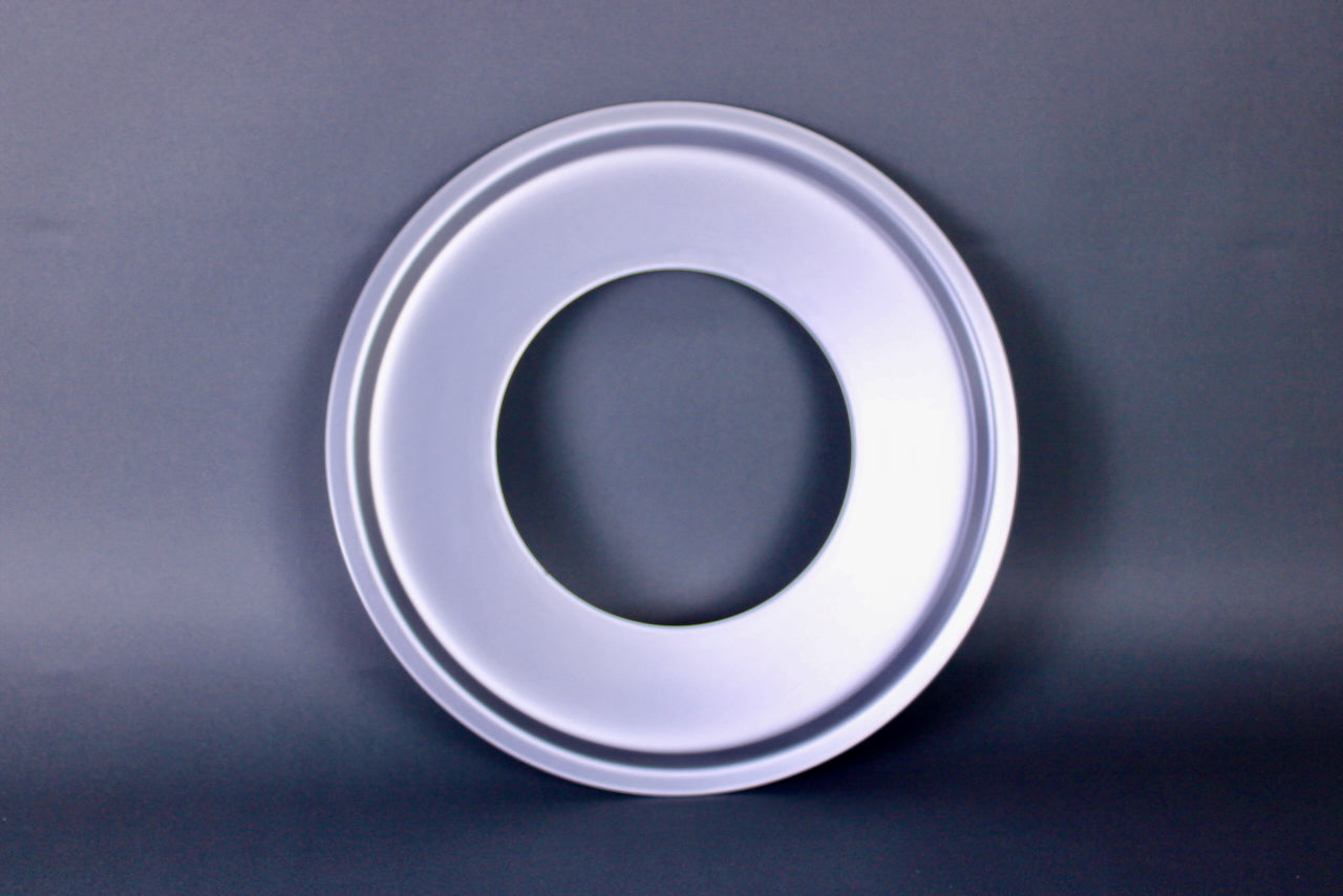 metalic shiny circular steam ring for bamboo steamer center hole dark grey background