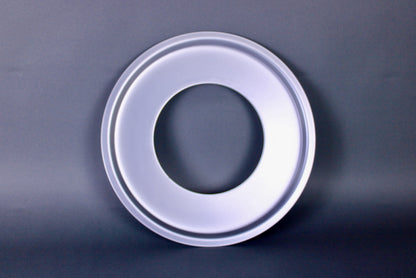 metalic shiny circular steam ring for bamboo steamer center hole dark grey background