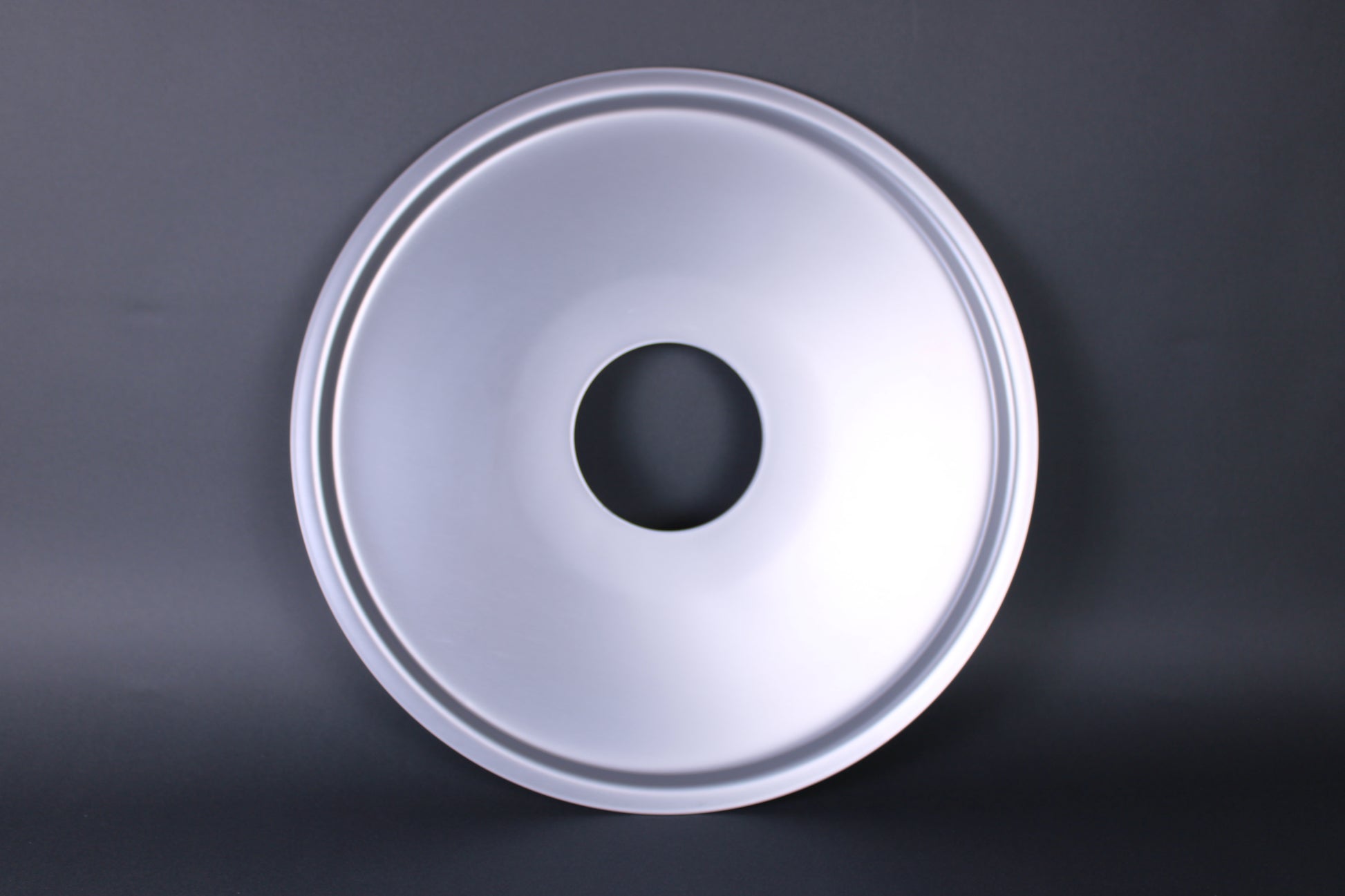 steam ring for cooking japanese kitchenware durable hole in the center to allow steam to pass through frontal shot of ring with grey background