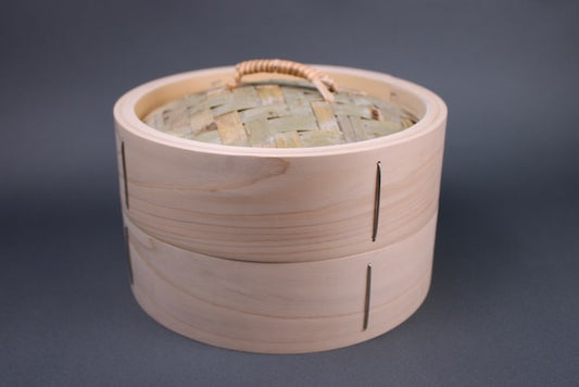  bamboo steamer twenty one cm kiso hinoki with thick walls made of hinoki woven lid made of bamboo and rattan handle with grey background 
