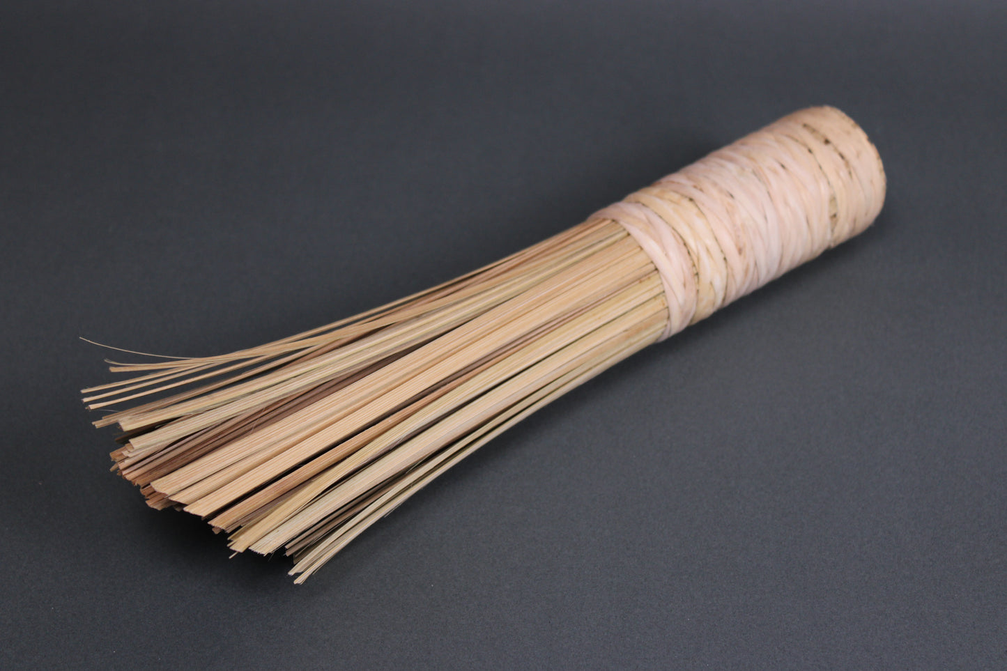 extra thick large short bamboo wok cleaning brush chan chi kee company angled shot with bristles up close grey background
