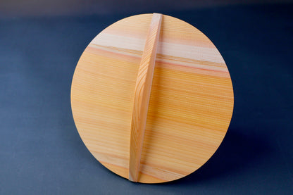 circular wooden drop lid for braising in grey background 