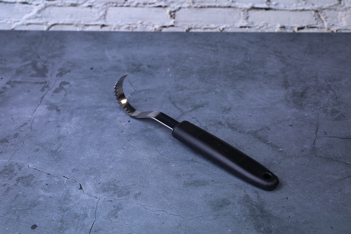 Butter curler and vegetable tool — side profile showing full curved blade, serrated edge, and black handle