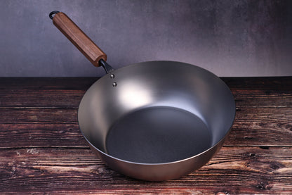 Carbon Steel Nitride deep fry pan 26cm showing dark nitride interior and walnut handle on wood surface