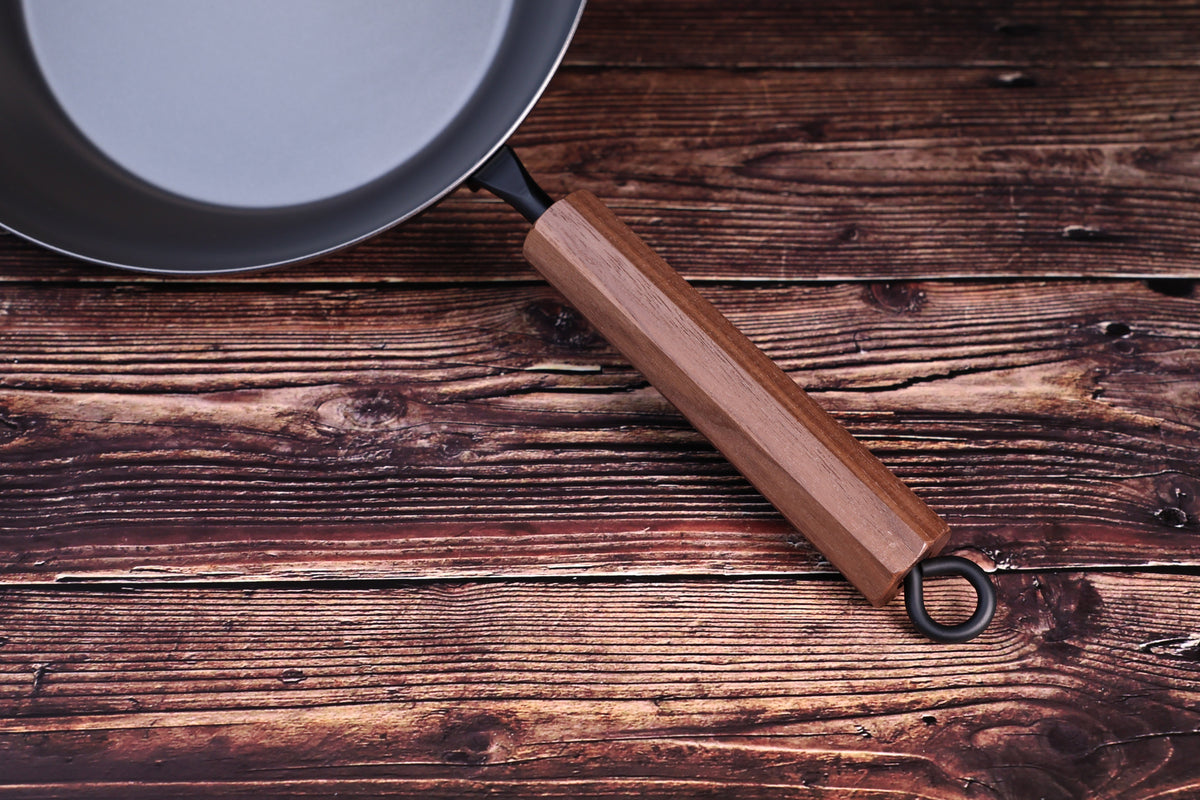 Carbon Steel Nitride deep fry pan 26cm close-up of octagonal walnut handle and black iron ring on wood