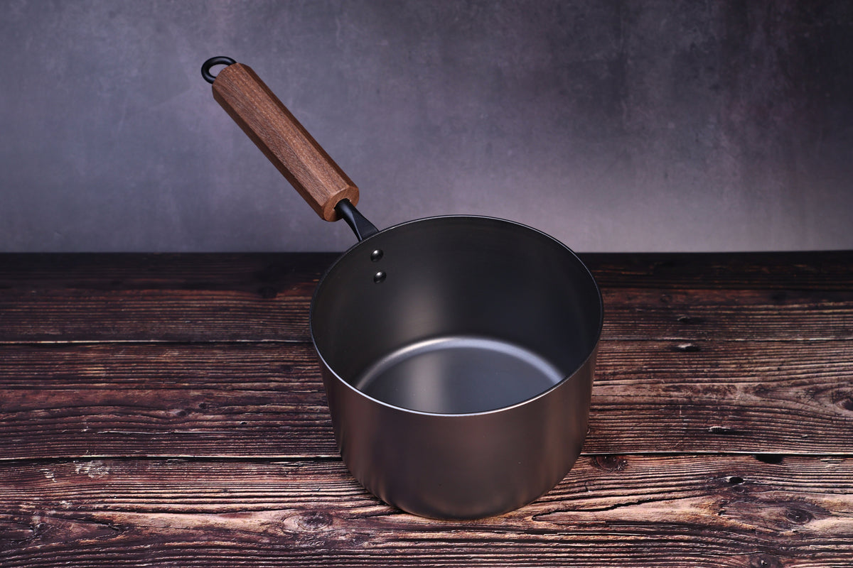 Carbon Steel Nitride saucepan 16cm close front view showing smooth dark nitride interior and walnut handle