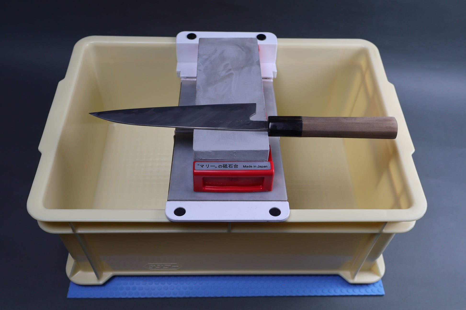 tall sharpening box Suehiro sliding rack Marie whetstone holder hasegawa non slip mat kit shown with kitchen knife horizontally placed grey background