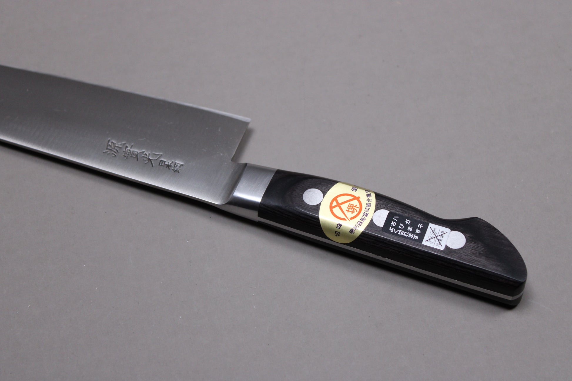 closeup of knife handle and kanji of carbon steel blade