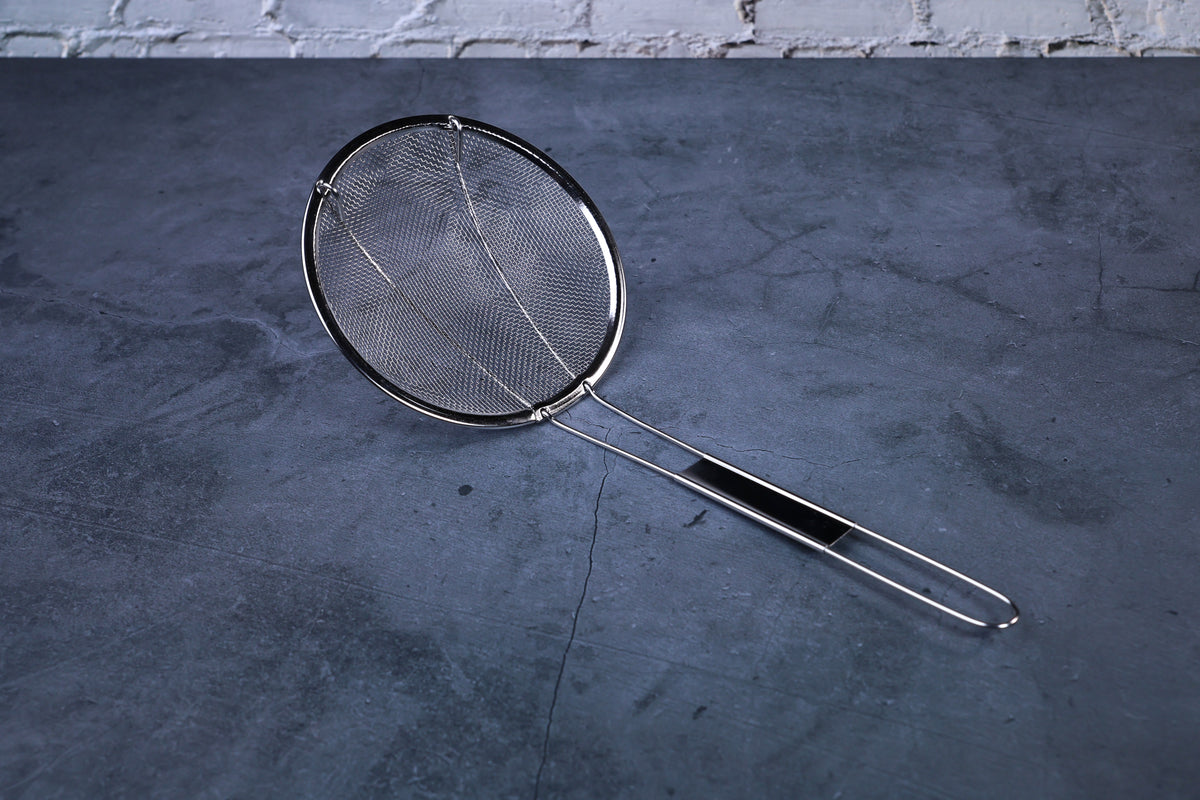 Coarse mesh skimmer — full view showing wire mesh basket, rim, and stainless handle on concrete