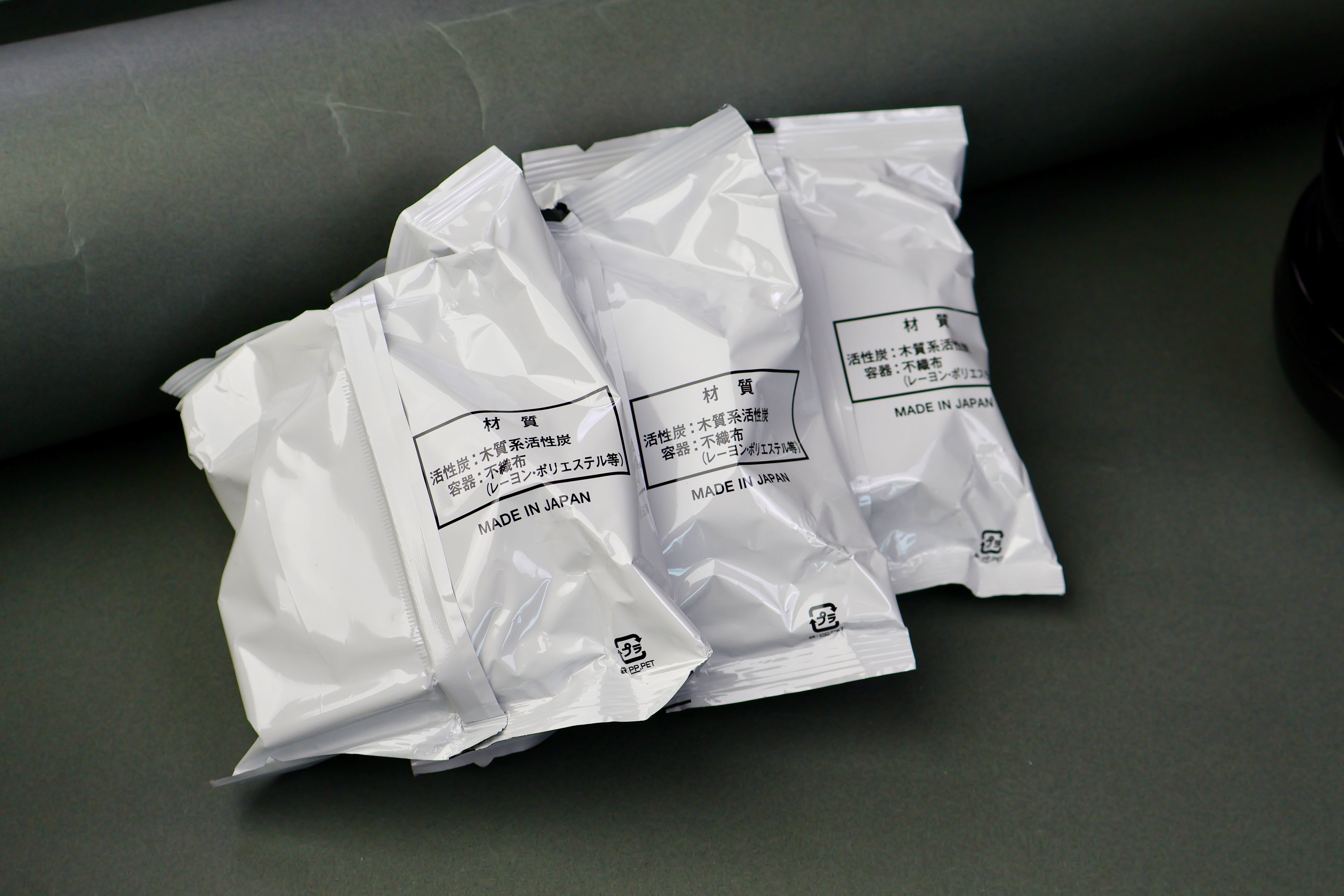 three white plastic kitchen oil filters in grey backdrop